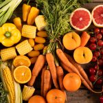 Overhead view of various fruits, vegetables and bell peppers on table