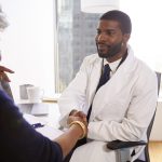 Senior Woman Shaking Hands With Male Doctor Cosmetic Surgeon In Office