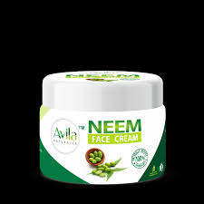 Jar of avila neem face cream against a black background.