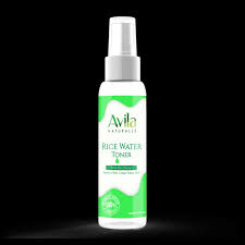 A bottle of avila rice water toner with a green and white label on a black background.