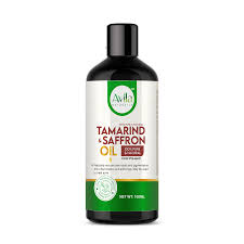 A bottle of avila tamarind saffron oil on a white background, labeled for glowing skin, 50ml size.