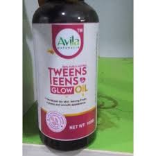 A bottle of avila tween teens glow oil on a white surface, with focus mainly on the product label.