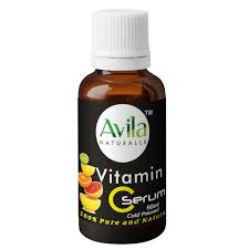 A small brown bottle labeled "Avila Vitamin C Serum," featuring images of citrus fruits and text indicating it's cold-pressed and natural.