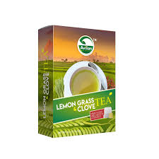 A box of lemon grass and clove tea featuring a cup of tea with green fields in the background.