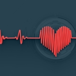 An electrocardiogram line forms the shape of a heart in the middle against a dark background.